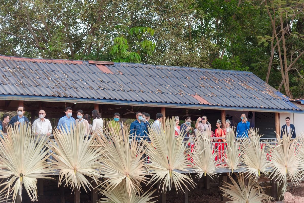 The home office TWELVE COM. built for Natan Village, with the community gathered outside
